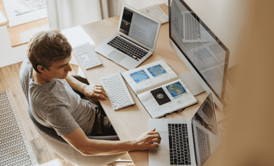 MAn in office working in front of his laptop