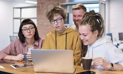 Young business people around a laptop