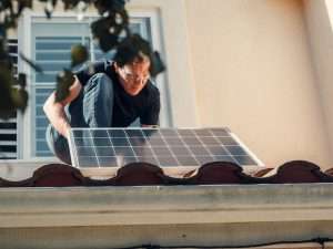 Man adjusting a solar panel