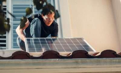 Man adjusting a solar panel