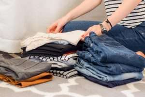 Woman folding jeans neatly