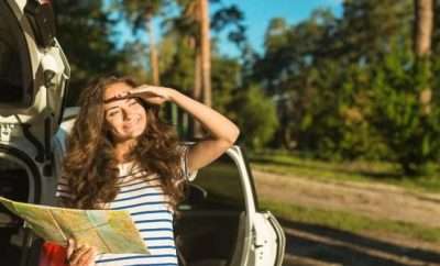 Woman on a road trip with a road map in her hands