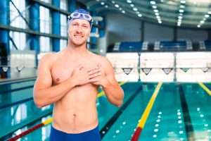 Male swimmer with back to pool