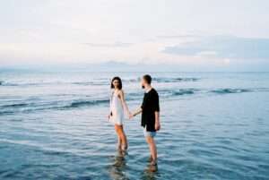 Couple holding hands at the beach