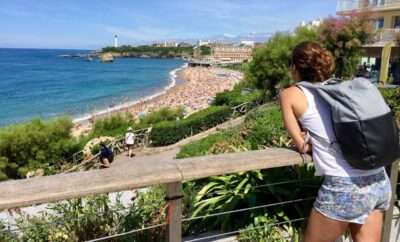 Woman with a backpack looking onto a Beach