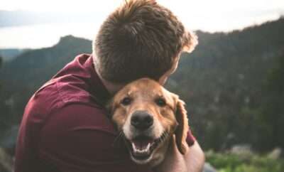 Man huggin his seniior dog