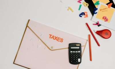 Calculator, pencils and envelop with 'Taxes' written on it