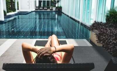 Woman by the pool side suntanning