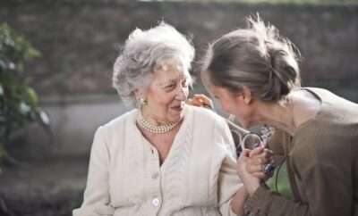 A senior lady talking to a career or daughter