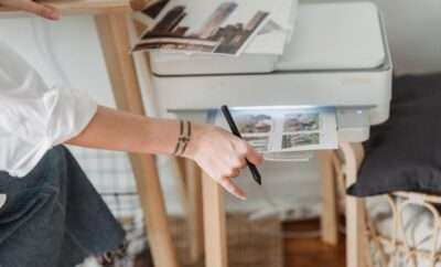 Woman next to a digital printer