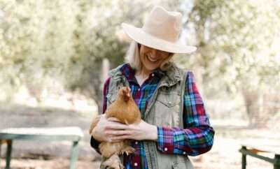 Woman holding a chicken