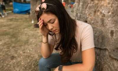 Woman with hand on her forehead