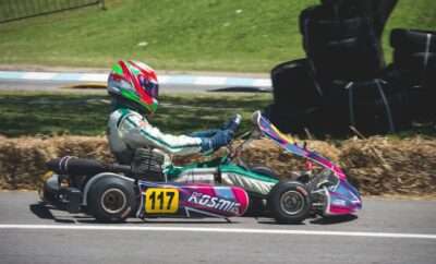 Picture of someone driving a colorful go kart.