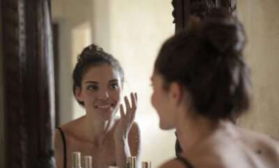 Woman happily looking at herself in the mirror