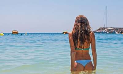 Woman at the beach with back towards us